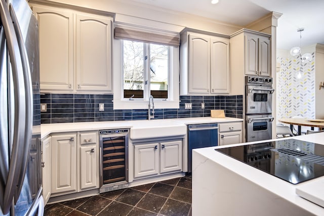 kitchen featuring backsplash, stainless steel appliances, sink, decorative light fixtures, and wine cooler