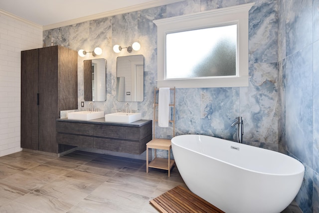 bathroom with vanity, crown molding, a tub to relax in, and tile walls