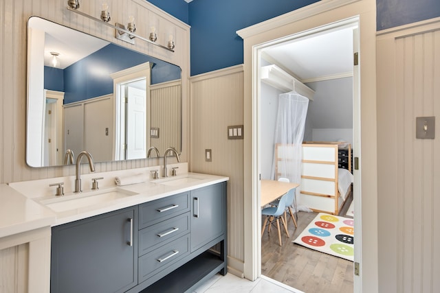 bathroom with vanity, wood-type flooring, and ornamental molding