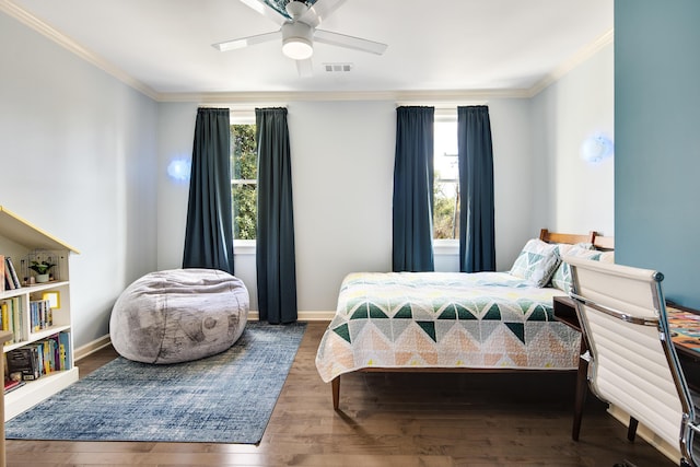 bedroom with wood-type flooring, ceiling fan, and ornamental molding