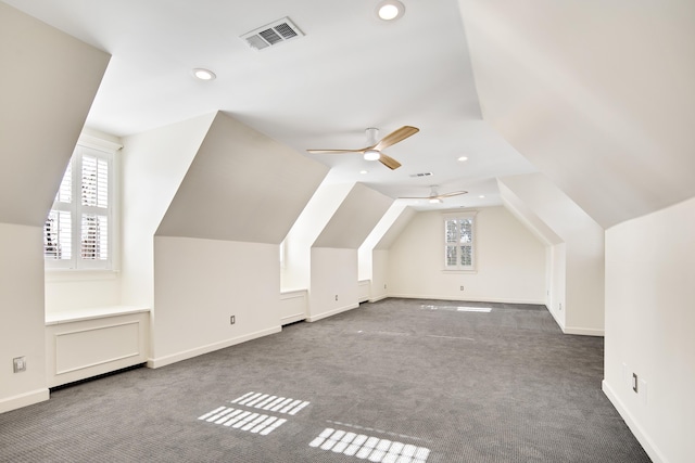 additional living space featuring carpet floors, vaulted ceiling, and ceiling fan