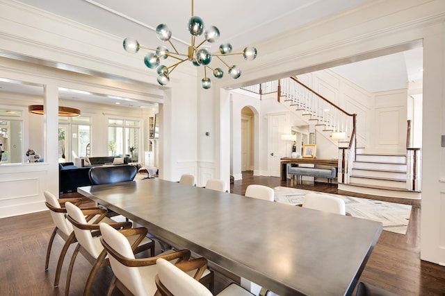 dining area with dark hardwood / wood-style flooring and a notable chandelier