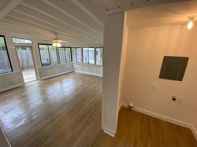 clothes washing area featuring hardwood / wood-style floors, ceiling fan, and electric panel