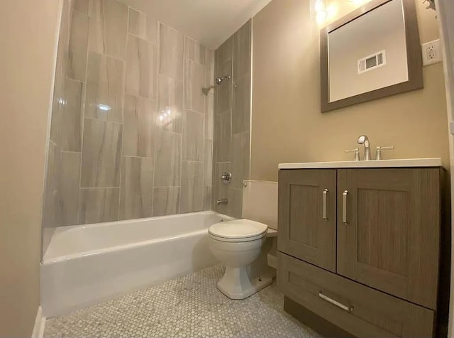 full bathroom featuring tile patterned flooring, tiled shower / bath combo, toilet, and vanity