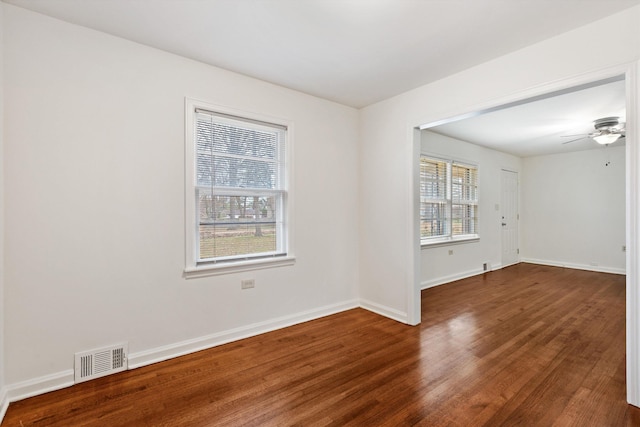 spare room with ceiling fan, dark hardwood / wood-style flooring, and a wealth of natural light