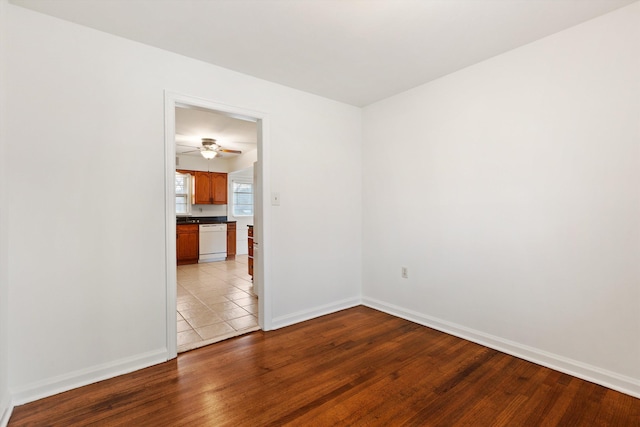 empty room with ceiling fan and light hardwood / wood-style floors