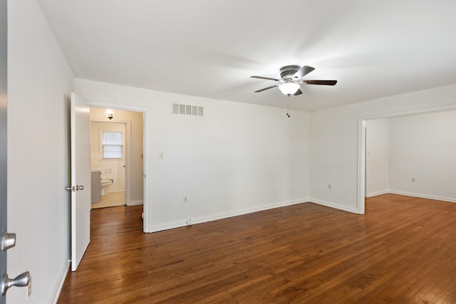 unfurnished room featuring ceiling fan and dark wood-type flooring