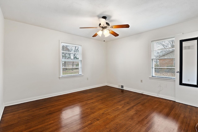 empty room featuring ceiling fan and dark hardwood / wood-style flooring