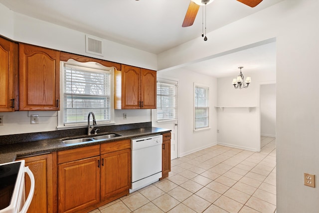 kitchen featuring sink, hanging light fixtures, white dishwasher, ceiling fan with notable chandelier, and range