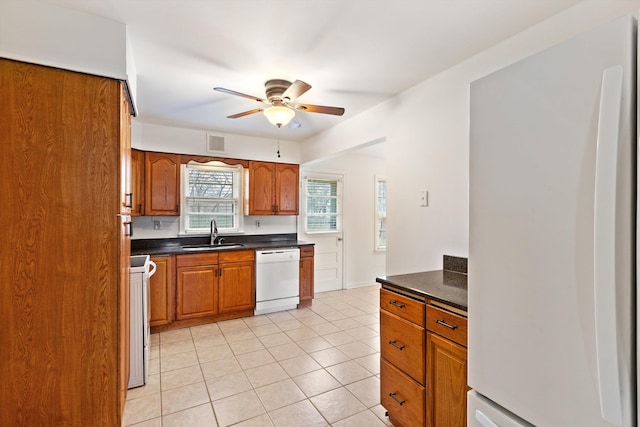 kitchen featuring ceiling fan, sink, light tile patterned floors, and white appliances