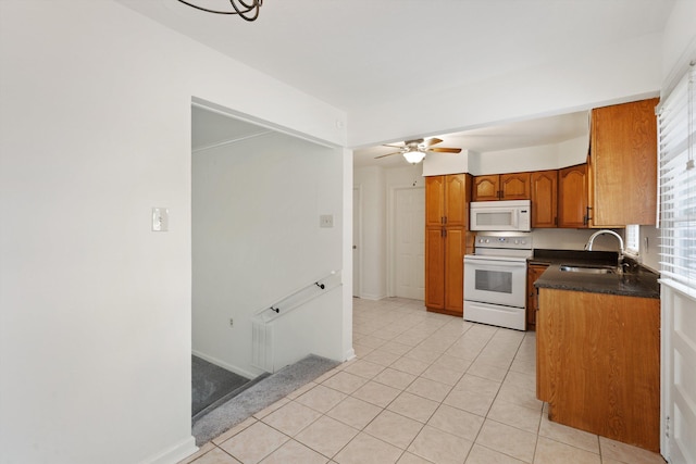 kitchen featuring light tile patterned flooring, white appliances, ceiling fan, and sink