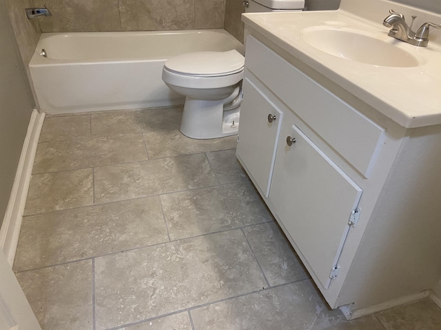 bathroom featuring vanity, toilet, and a bath