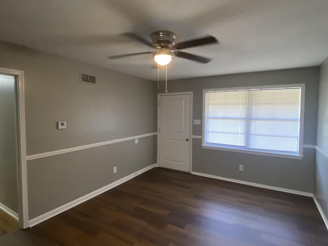 empty room featuring ceiling fan and dark hardwood / wood-style flooring