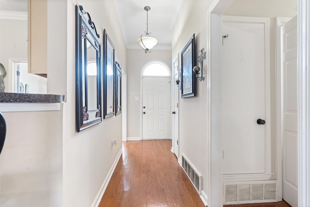 interior space with hardwood / wood-style floors and ornamental molding