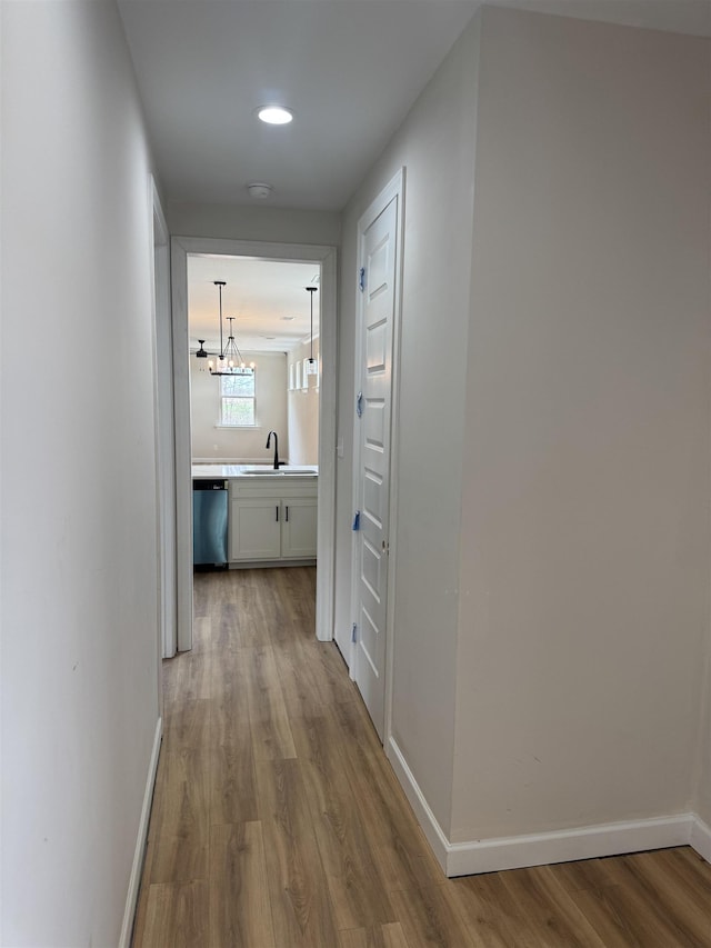 5549 Shipp Rd, Millington, TN 38053 - corridor featuring wood finished floors, a sink, baseboards, a chandelier, and recessed lighting