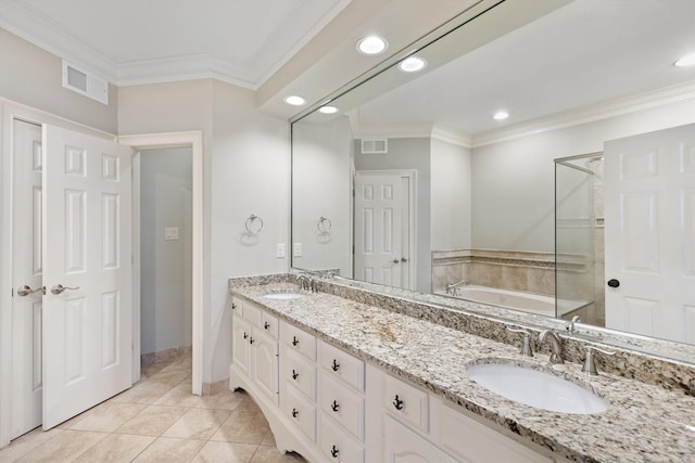 bathroom featuring tile patterned flooring, vanity, ornamental molding, and a washtub