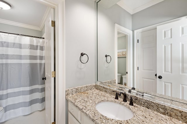 bathroom featuring vanity, toilet, and ornamental molding