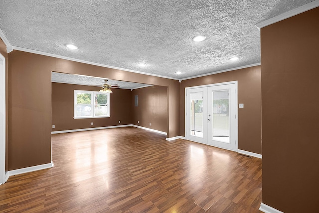 foyer entrance with french doors, crown molding, ceiling fan, a textured ceiling, and wood-type flooring