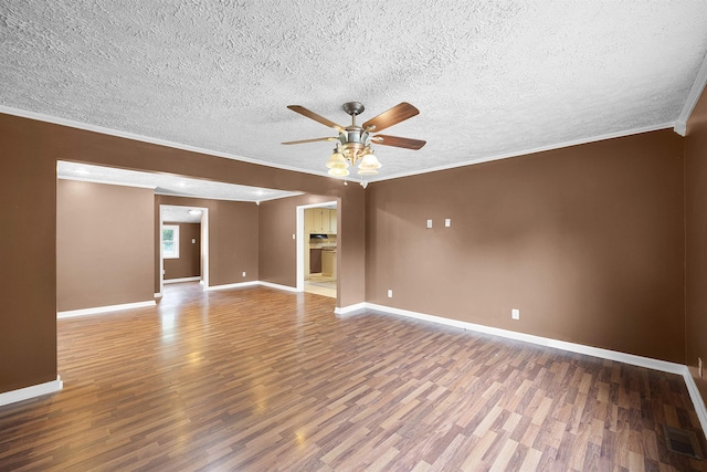 empty room with wood-type flooring, a textured ceiling, ceiling fan, and ornamental molding