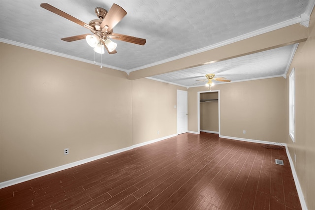 unfurnished room with crown molding, dark hardwood / wood-style flooring, and a textured ceiling