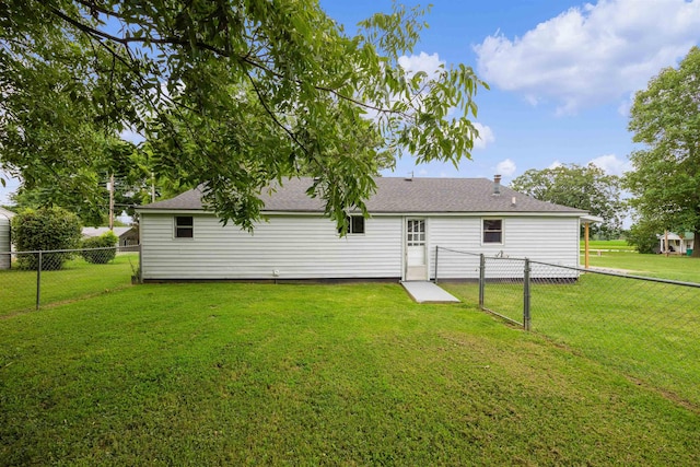 rear view of house with a yard