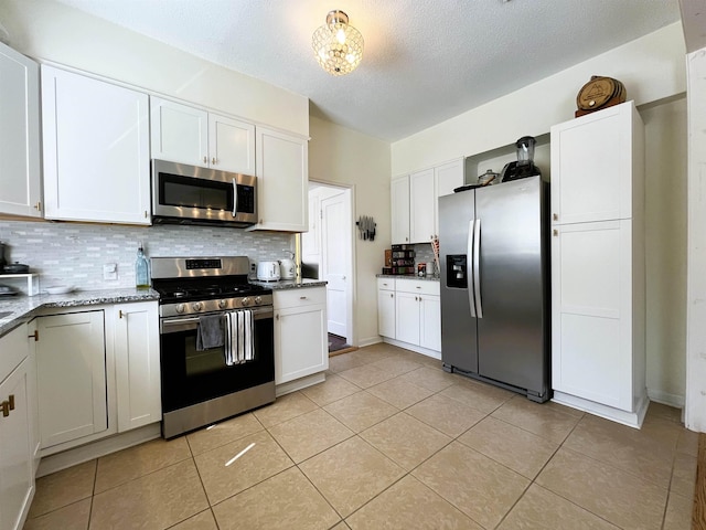 kitchen with appliances with stainless steel finishes and white cabinetry