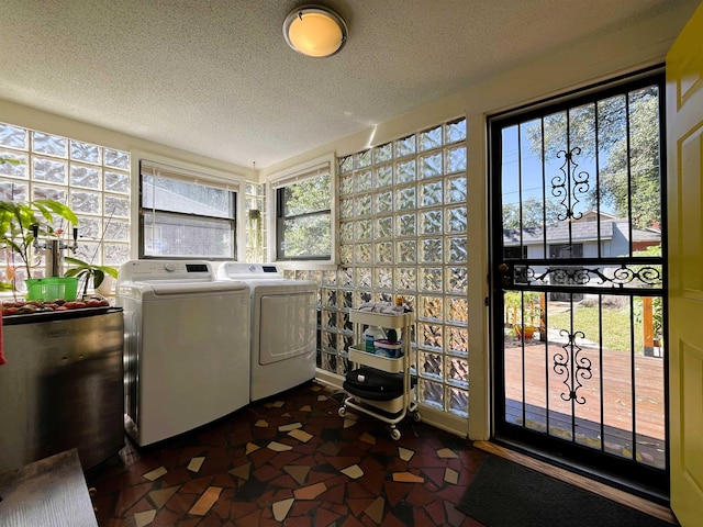 laundry area featuring independent washer and dryer and a textured ceiling