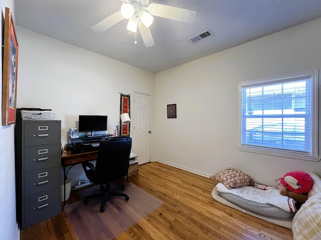 office with ceiling fan and hardwood / wood-style floors