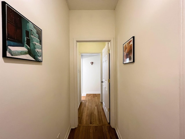 hallway with dark hardwood / wood-style flooring