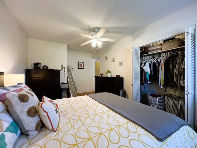 bedroom with ceiling fan, a closet, and wood-type flooring