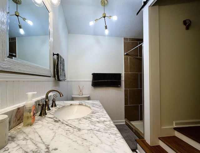 bathroom featuring a tile shower and vanity