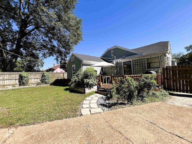 rear view of property featuring a yard