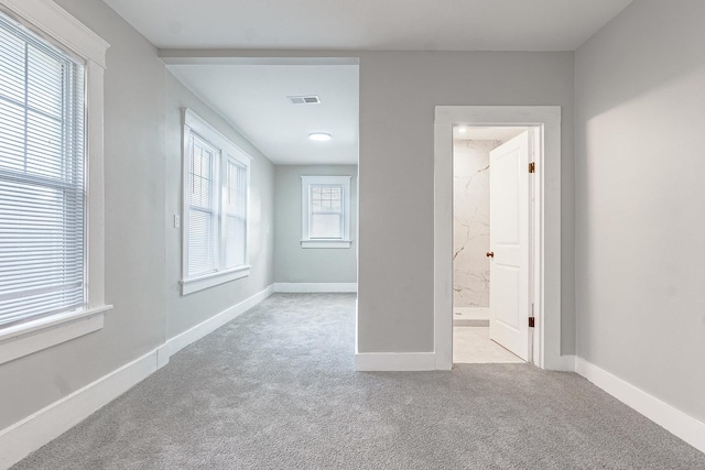 empty room featuring light colored carpet