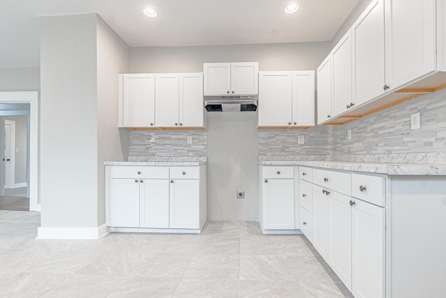 kitchen featuring decorative backsplash and white cabinetry