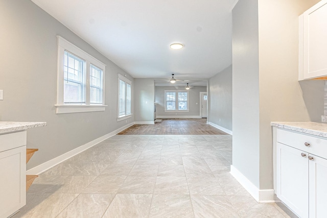 interior space with ceiling fan