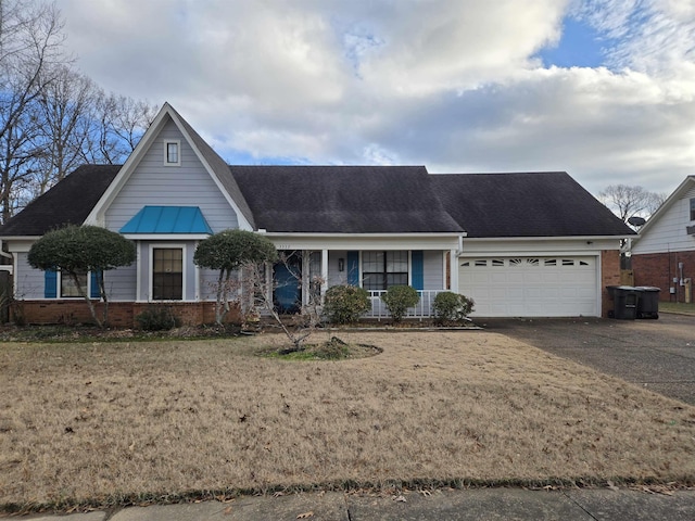 view of front of property featuring a garage, driveway, brick siding, and a front lawn