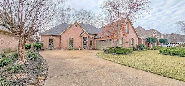 view of front of property featuring a garage and a front lawn