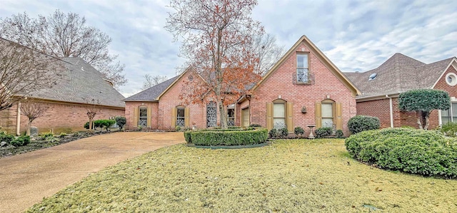 tudor-style house with a front yard