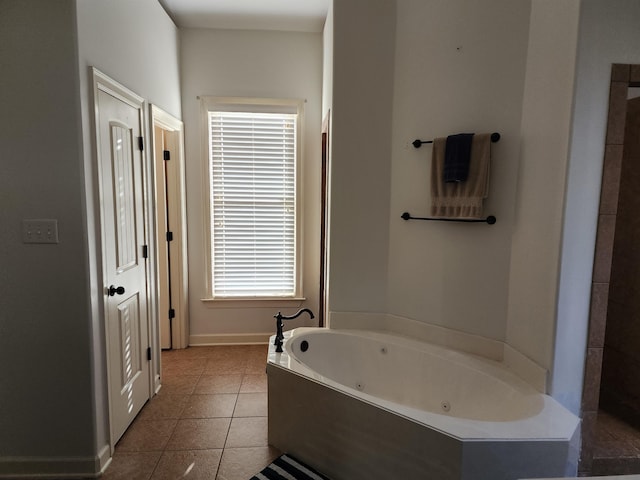 bathroom with tile patterned floors and a tub