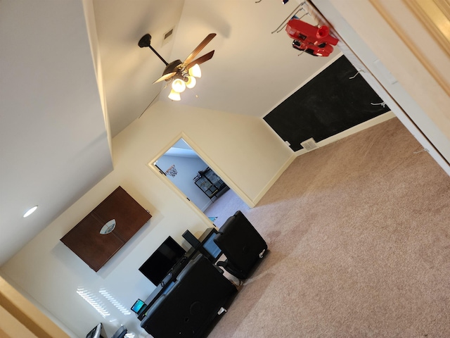 unfurnished living room with ceiling fan, light colored carpet, and lofted ceiling