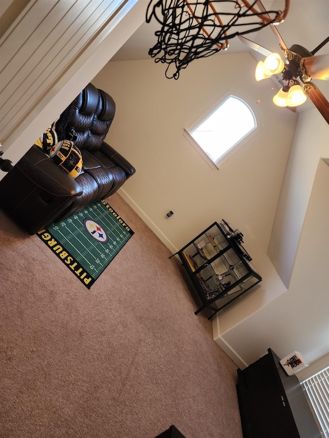 unfurnished living room with carpet and ceiling fan