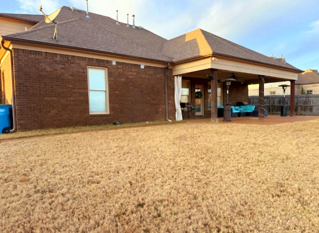 rear view of house with an outdoor living space, a patio, and ceiling fan