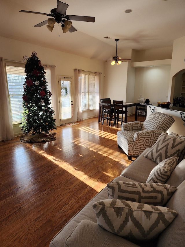 living room with plenty of natural light, ceiling fan, light hardwood / wood-style floors, and vaulted ceiling