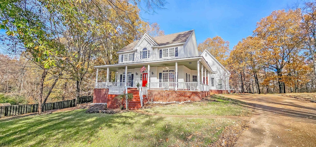 country-style home with a porch and a front yard