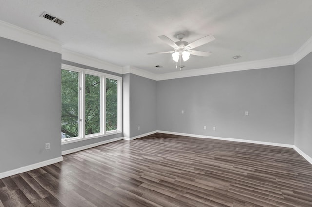 empty room featuring plenty of natural light, dark hardwood / wood-style floors, crown molding, and ceiling fan