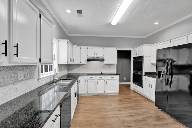 kitchen with dark stone counters, crown molding, sink, black appliances, and white cabinetry