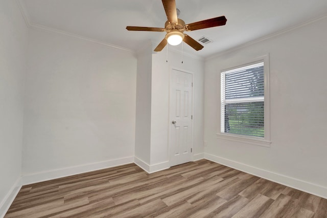 empty room featuring crown molding, ceiling fan, and light wood-type flooring