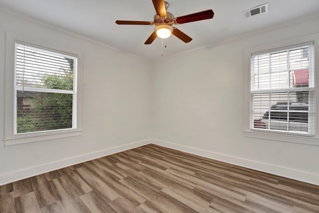 spare room featuring hardwood / wood-style flooring, ceiling fan, and ornamental molding