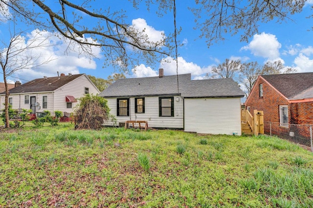 rear view of property featuring a yard