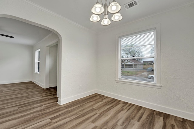 unfurnished room featuring crown molding, ceiling fan with notable chandelier, and hardwood / wood-style flooring